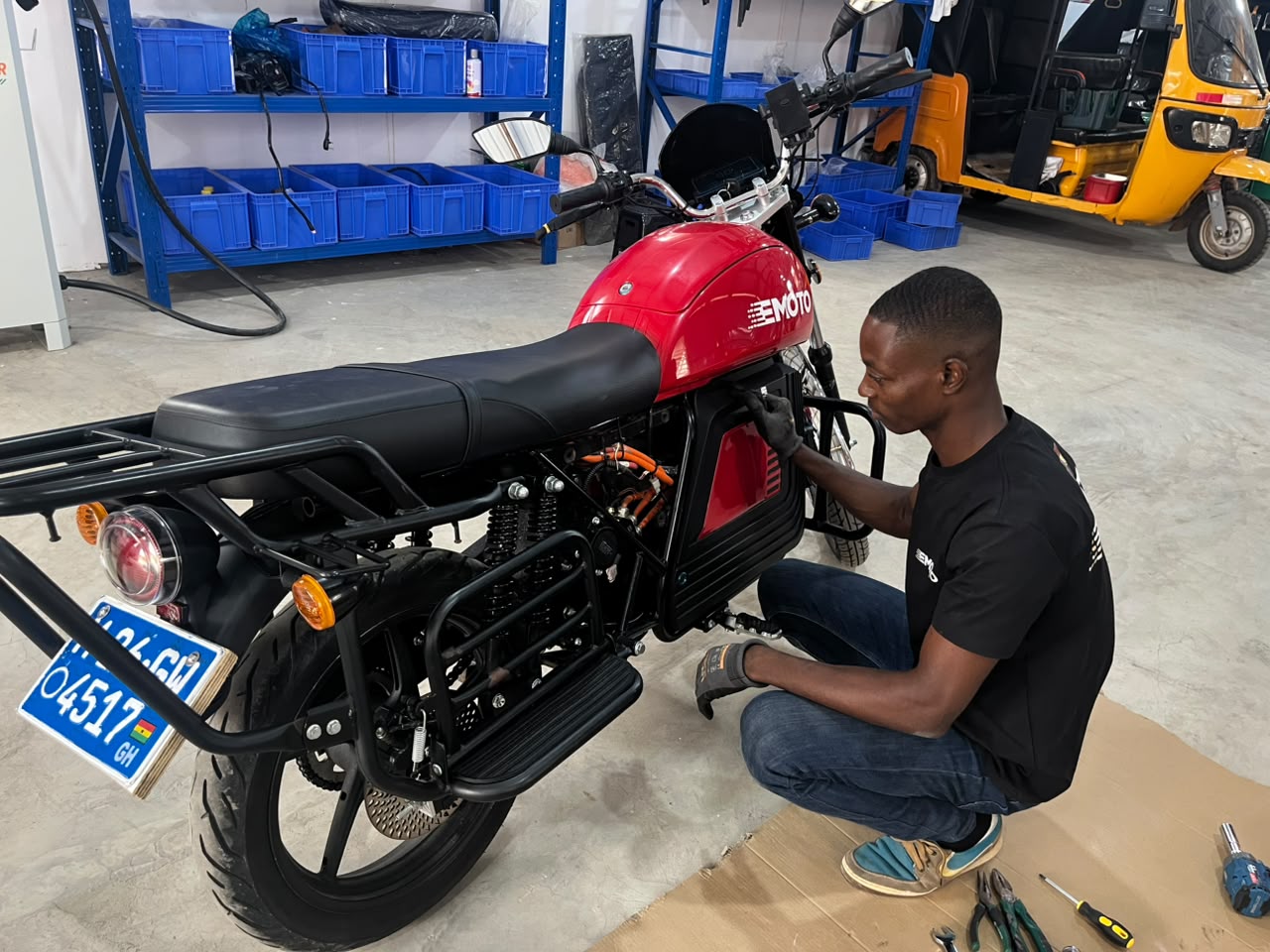EMoto technician repairing an electric motorcycle in a workshop